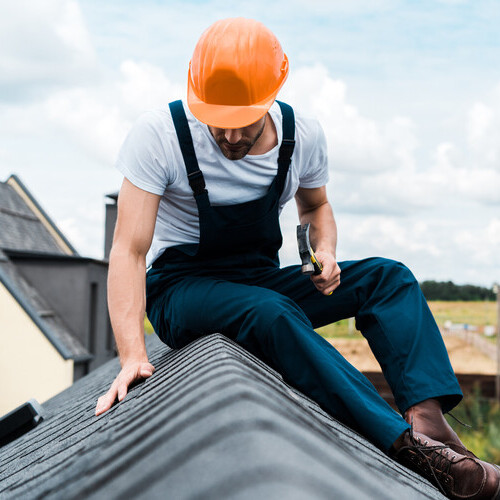 A worker inspecting a roof