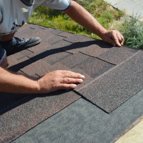 A worker repairing a roof leak